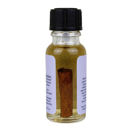 Small glass bottle with a cinnamon stick on a white background