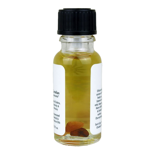 Small glass bottle with black cap and white label on a white background with carnelian chips