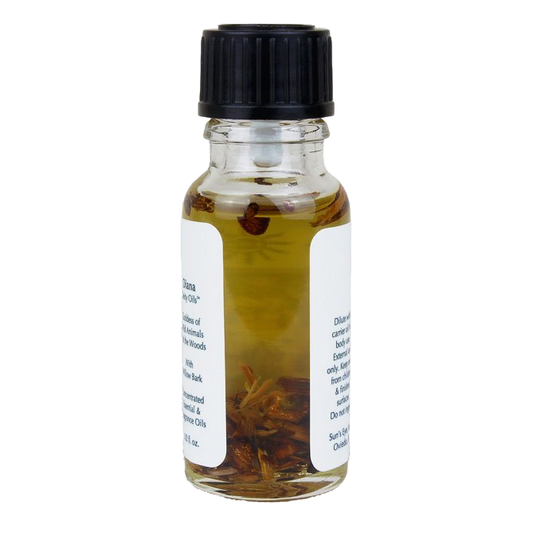 Small glass bottle with a black cap containing a liquid and herbs on a white background