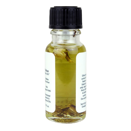 Small glass bottle with a black cap containing a liquid and herbs on a white background