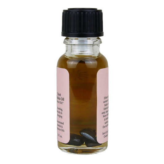 Small glass bottle with black cap and pink label on a white background