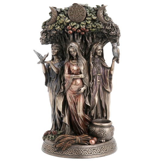 A detailed fantasy figurine of three goddesses under a tree with moon phases and berries, on a decorative base with a cauldron and wheat, shown against a plain white background.