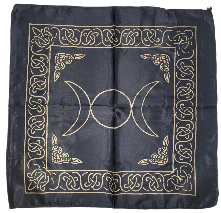 A black satin altar cloth with gold printed triple moon symbol and intricate patterns.
