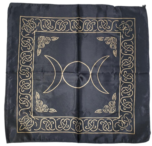 A black satin altar cloth with gold printed triple moon symbol and intricate patterns.